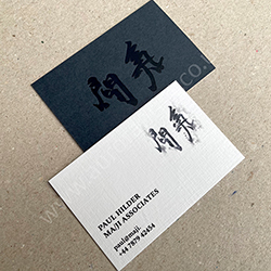 Slate grey and embossed pristine white card with black print and matt black logo.